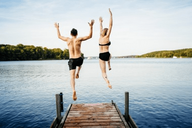 two people jumping into water